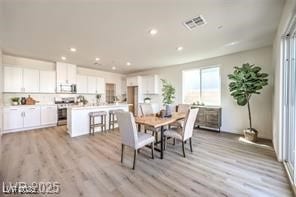 Dining room with light wood-style flooring and rec