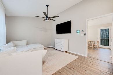 Living room featuring light wood-style flooring, c