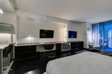 Bedroom with a wall of windows, wood finished floo