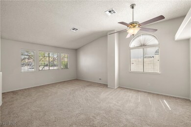 Carpeted empty room with a ceiling fan, lofted cei
