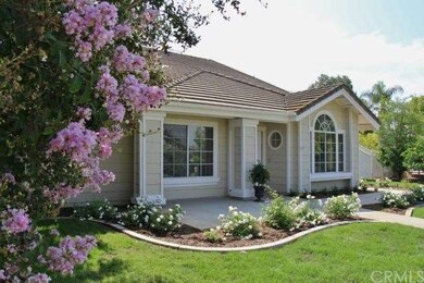 Front yard features new grass and rose bushes. 