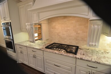 Here's a fun feature-- The Corbels slide out to reveal dual spice racks over the five-burner gas cooktop.