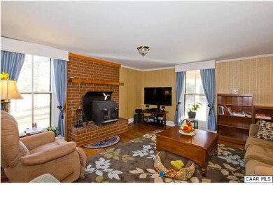 Brick Surround Fireplace in Greatroom with Woodsto