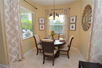 Kitchen island with a snack bar is adjacent to the