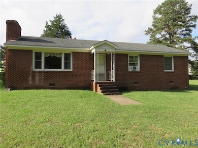Single story home featuring crawl space, a chimney, a front lawn, brick siding, and roof with shingles