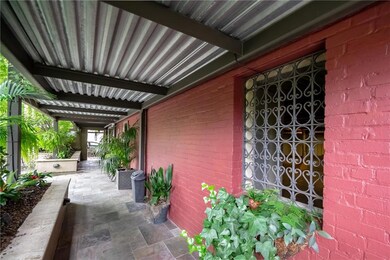 Gated entry from Rampart leads to covered entryway