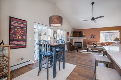 Dining room featuring high vaulted ceiling, a fire