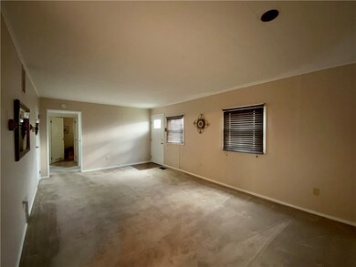 Living room leads to the 3 bedrooms and full bath