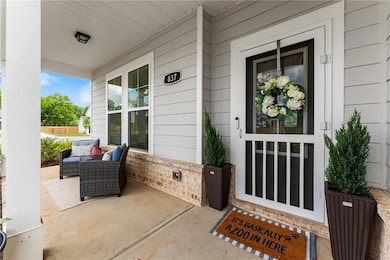 Front porch surrounded by beautiful shrubbery