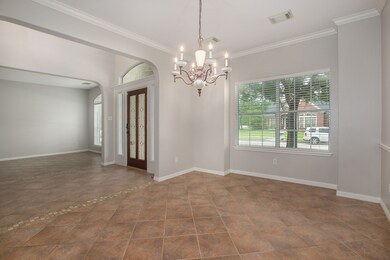 A classic chandelier anchors the space, complete with a large picture window overlooking the front yard space!  Imagine family meals or late night card games with the neighbors taking place here!
