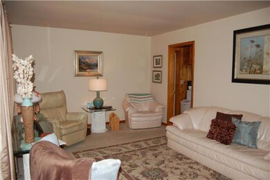 Large family room with hardwood floors under the carpet. 