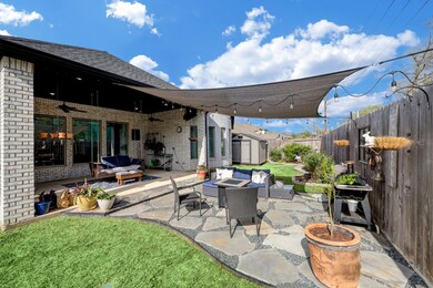 Peaceful retreat afforded by this deep covered patio and custom extension perfect for grilling out, fire pit, and additional seating!
