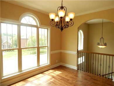 Formal dining room has beautiful window.