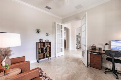 Home office featuring ornamental molding, light ti