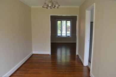 A view from the dining room, looking toward the Living Room. Kitchen entry is on the right.