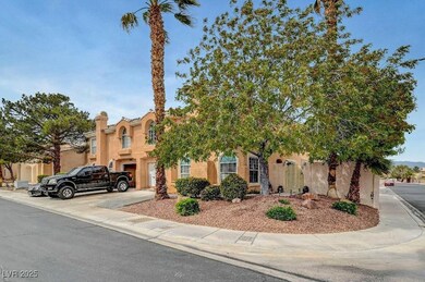 View of front facade with driveway, stucco siding,
