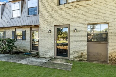 View of exterior entry featuring a yard