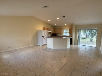 Kitchen with white refrigerator with ice dispenser