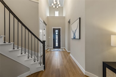 A beautiful foyer at the front of the home with soaring ceilings.