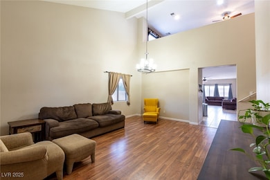 Living room featuring high vaulted ceiling