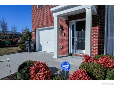 Concrete driveway to attached one-car direct entry garage, plus covered stoop.