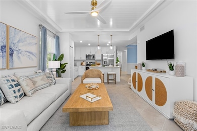 Living room featuring ceiling fan and light tile patterned floors
