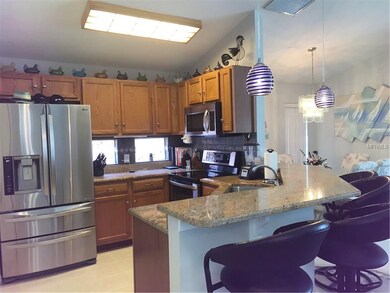 Kitchen features granite counter tops, tile back s