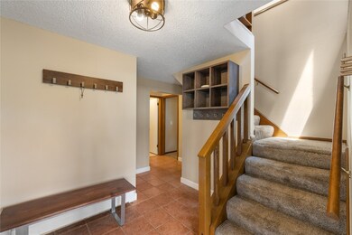 Staircase with tile patterned flooring, baseboards