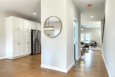 Hallway off the front entry leads to the hall half