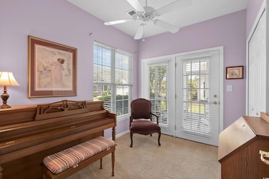 Flex area featuring ceiling fan, light carpet and 