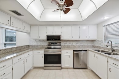 Kitchen featuring stainless steel appliances, a sink, healthy amount of natural light, and ceiling fan