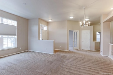View from living room looking toward front door and den/office
