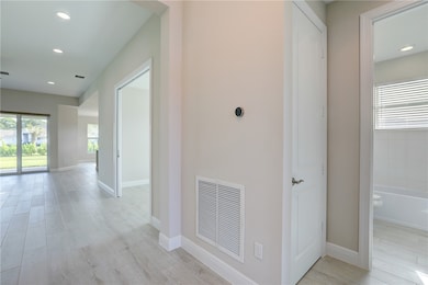 Hall featuring light wood-style flooring and recessed lighting