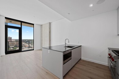 Kitchen with stainless steel appliances, light wo