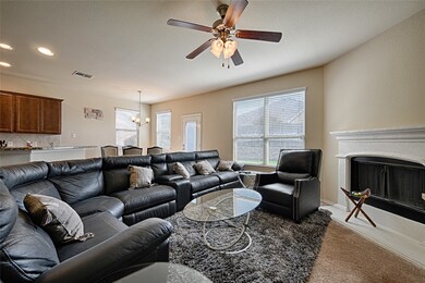 Living room featuring carpet flooring, a chandelier, a fireplace, recessed lighting, and ceiling fan