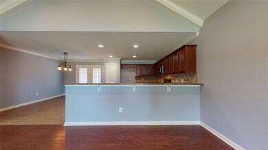 Den looks onto Kitchen