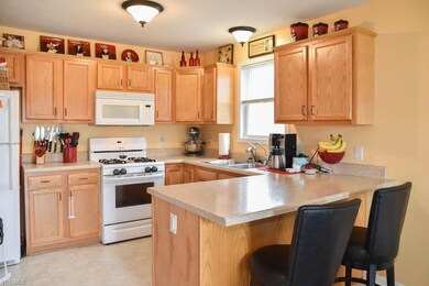 Fully applianced kitchen with a breakfast bar.