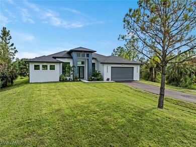 Prairie-style home featuring stucco siding, drivew