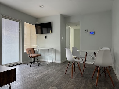 Dining space with wood finished floors and baseboa