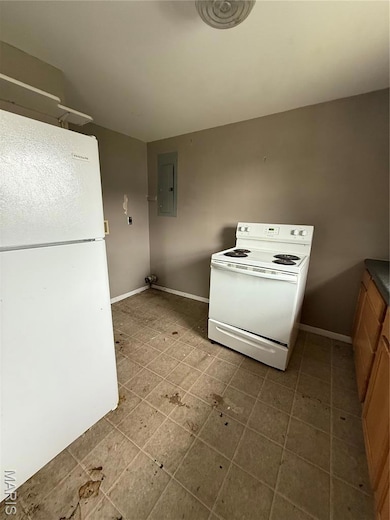 Kitchen featuring range, fridge, electric panel, and tile patterned floors