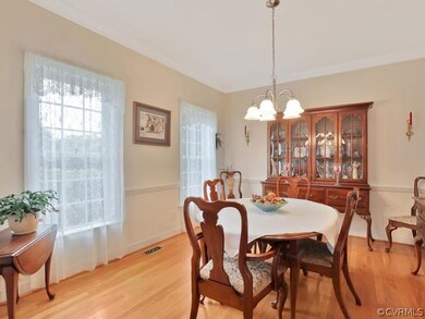 Dining Room, 11’ x 13’, nine-foot ceiling, hardwood floor, chandelier, crown moulding, chair rail moulding