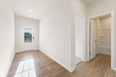 Doorway to outside featuring light wood-style floors and baseboards