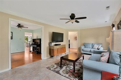 Spacious family room with ceiling fan, crown moldi