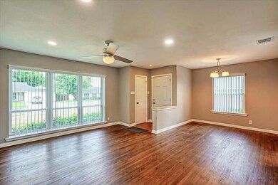 Spare room with dark wood-type flooring, baseboard
