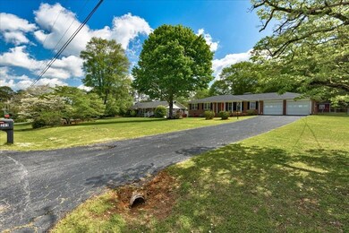 Ranch-style home featuring an attached garage, aph