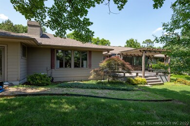 Back of house with built in seating and pergola on