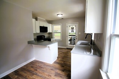 Kitchen with a breakfast bar area, black appliance