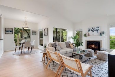 Living area with light wood finished floors, a ti