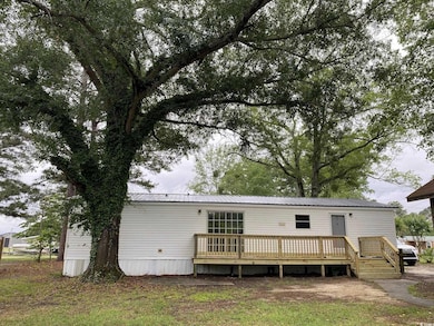Back of property featuring a deck and metal roof
