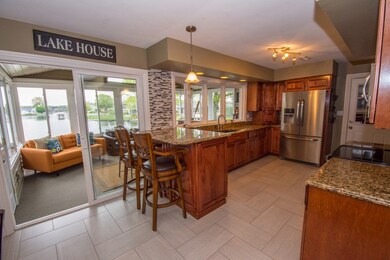 The generous kitchen features beautiful granite to